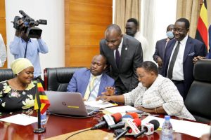 Prime Minister Robinah Nabbanja flanked by Henry Musasizi pressing the computer button to release PDM funds.