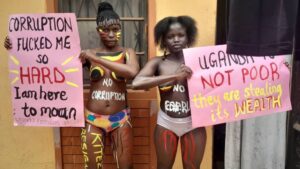 Two of the three half naked women taking the matter of fighting corruptiin by staging a demonstration within the vicinity of Parliament. Their bodies inscribed with words calling on the Speaker to resign and carrying placards were their only weapons to send chilling shockw waves to police who swung into action of brutally arresting them. They were arraigned in court and remanded thereafter.

The Chairperson of Uganda Human Rivhts Commission condemned the police for arresting these women asserting that they were expressing their human rights.  