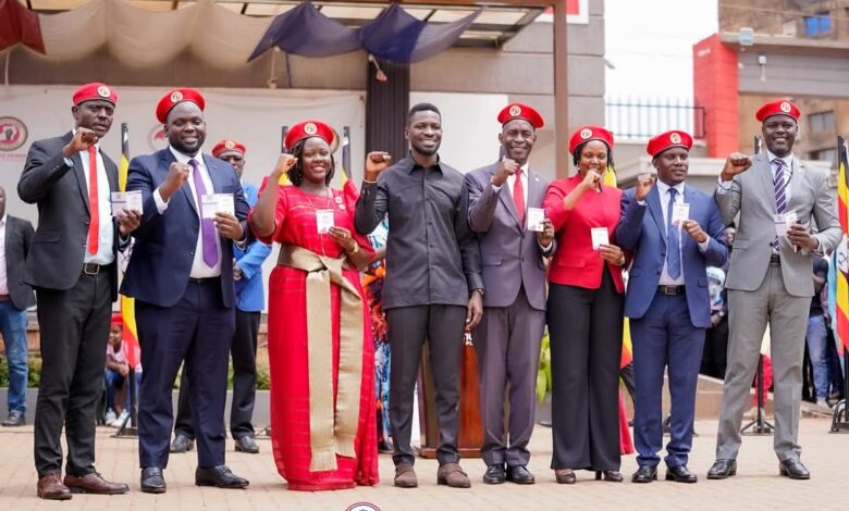Group photo of the seven MPs at the NUP headquarters with Bobi Wine.