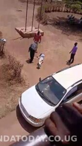 A savage and uncouth Director St. James Lira School of Nursing flogging a man at his institute.